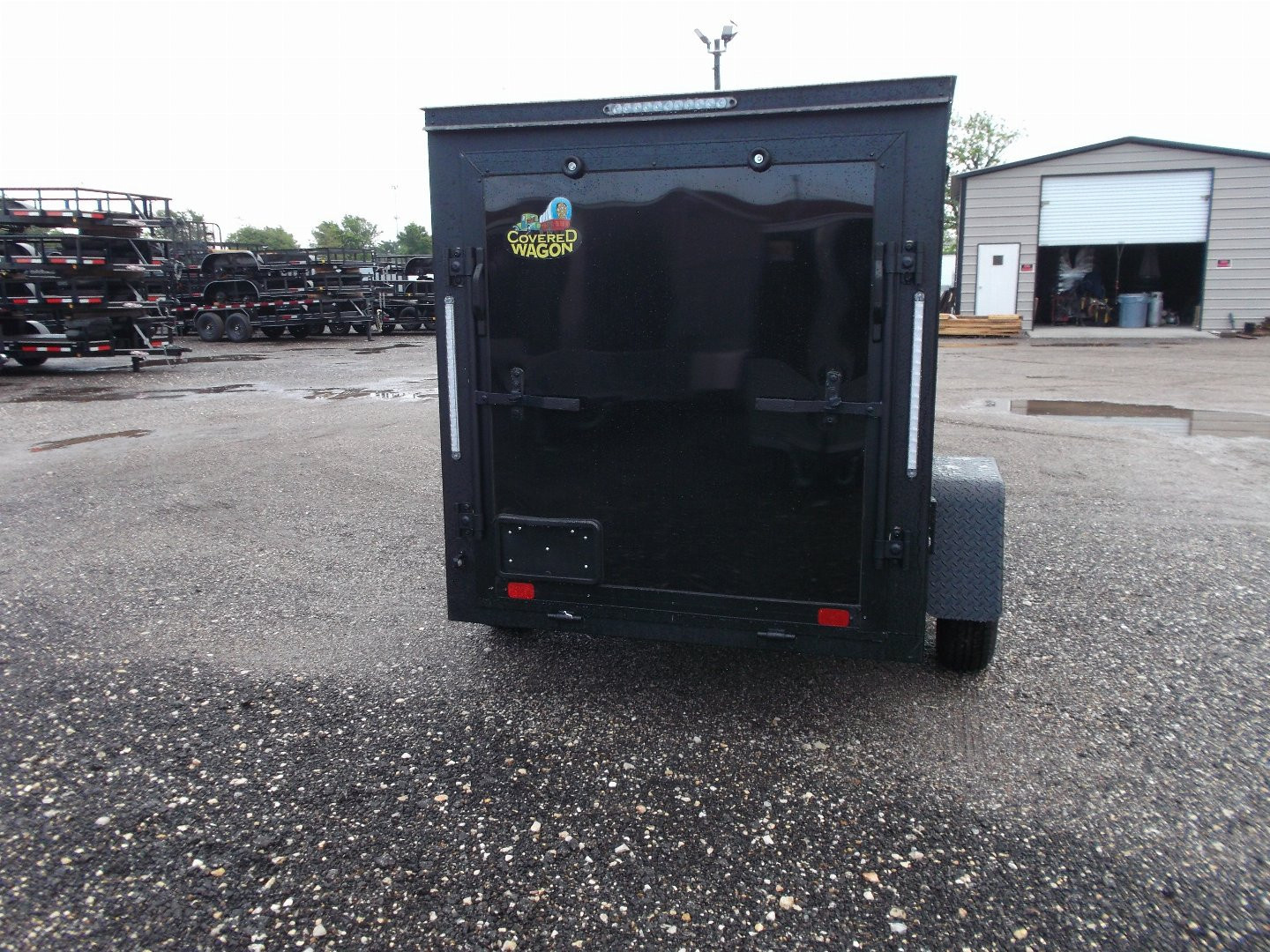 New 2026 Covered Wagon Trailers 5x8 Cargo Trailer / Enclosed Trailer / Ramp / Side Door / .030 Black Semi-Screwless Exterior / Bed Lined Tongue and Frame / Black Out Package