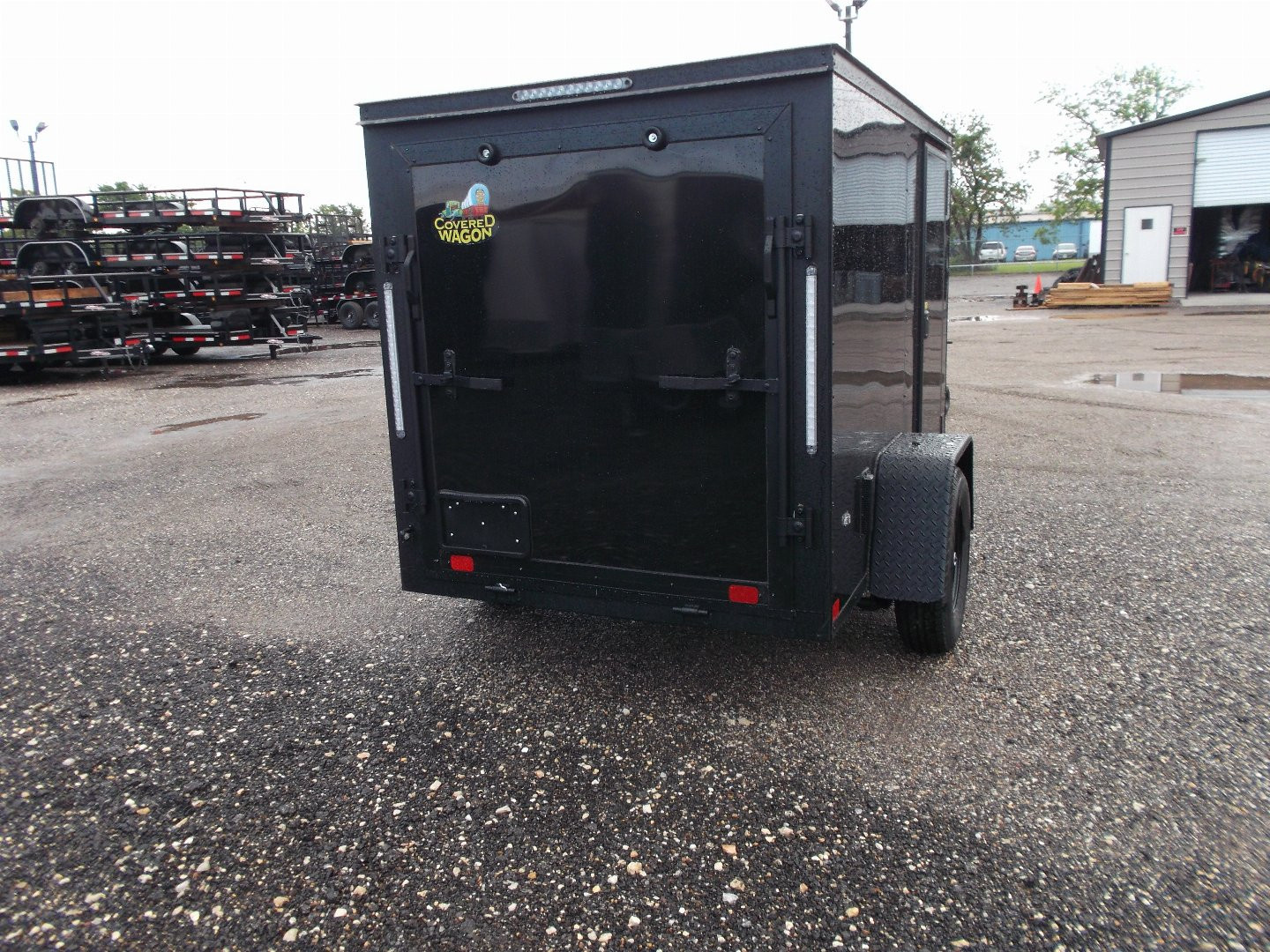 New 2026 Covered Wagon Trailers 5x8 Cargo Trailer / Enclosed Trailer / Ramp / Side Door / .030 Black Semi-Screwless Exterior / Bed Lined Tongue and Frame / Black Out Package