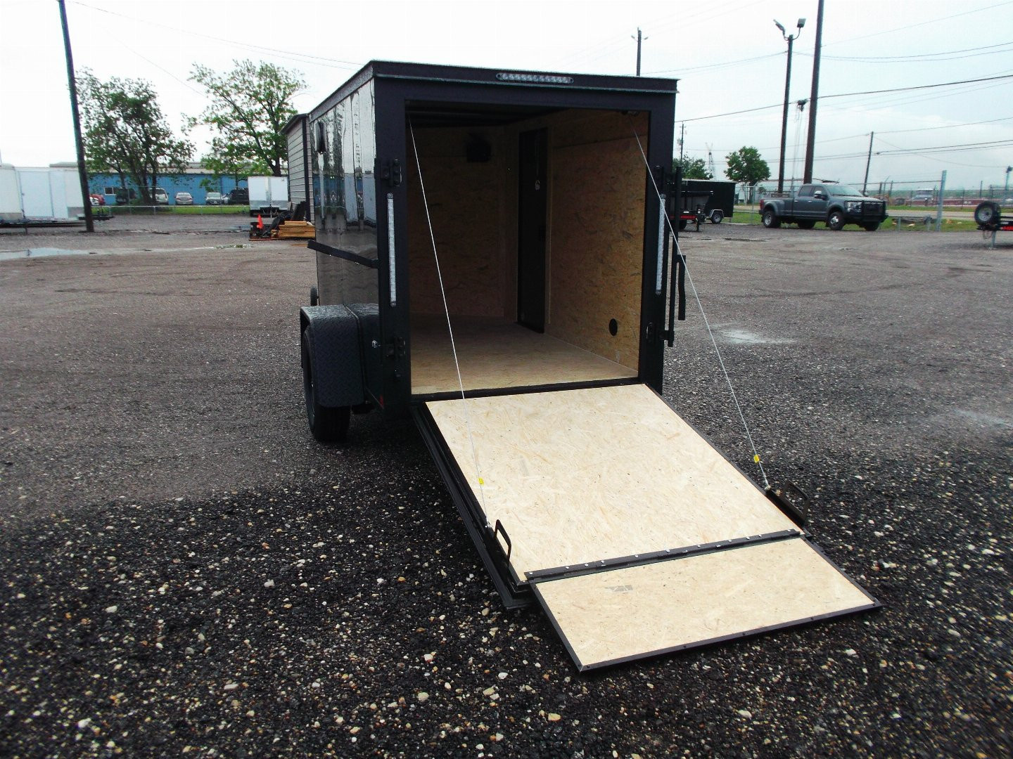 New 2026 Covered Wagon Trailers 5x8 Cargo Trailer / Enclosed Trailer / Ramp / Side Door / .030 Black Semi-Screwless Exterior / Bed Lined Tongue and Frame / Black Out Package