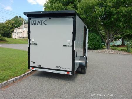 New EXAMPLE / ATC 6X12 with 6'6" interior height, black trim, electric brakes, rear spoiler, battery and lights, step at side door. ID#235268 , $9,695.00