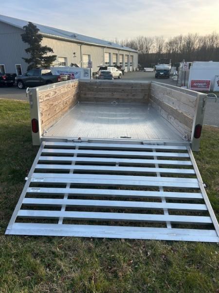 New QUALITY S&A BRAND ,  7 X 12 open utility trailer, Aluminum Frame and Deck, 2 ft. high sides, Bi-fold Ramp, 2,990 GVWR, 830 lbs. empty weight. ID#244735