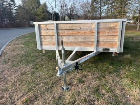 New QUALITY S&A BRAND ,  7 X 12 open utility trailer, Aluminum Frame and Deck, 2 ft. high sides, Bi-fold Ramp, 2,990 GVWR, 830 lbs. empty weight. ID#244735