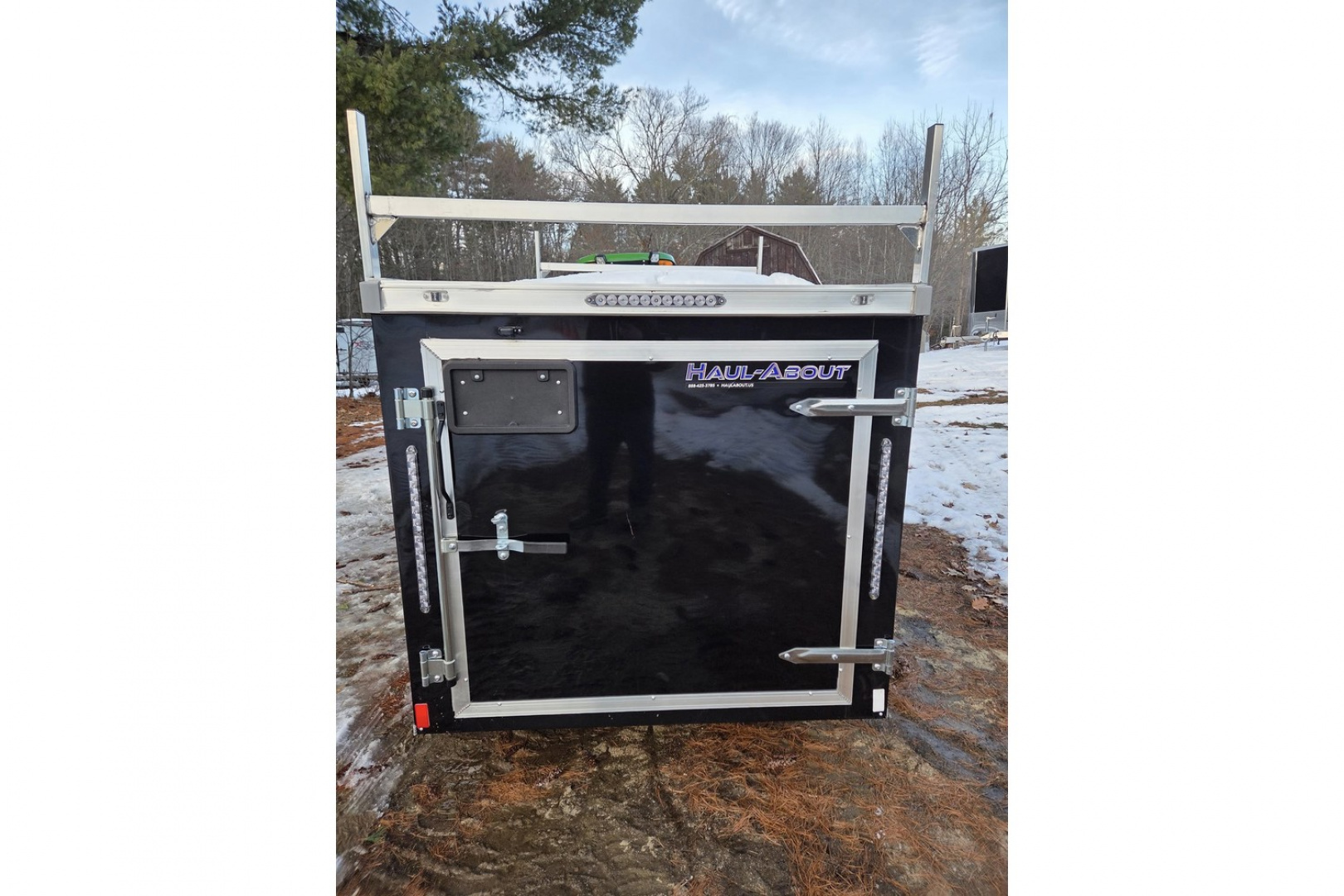 New 2026 5x10 enclosed cargo trailer with barn doors and ladder racks - Haul-About