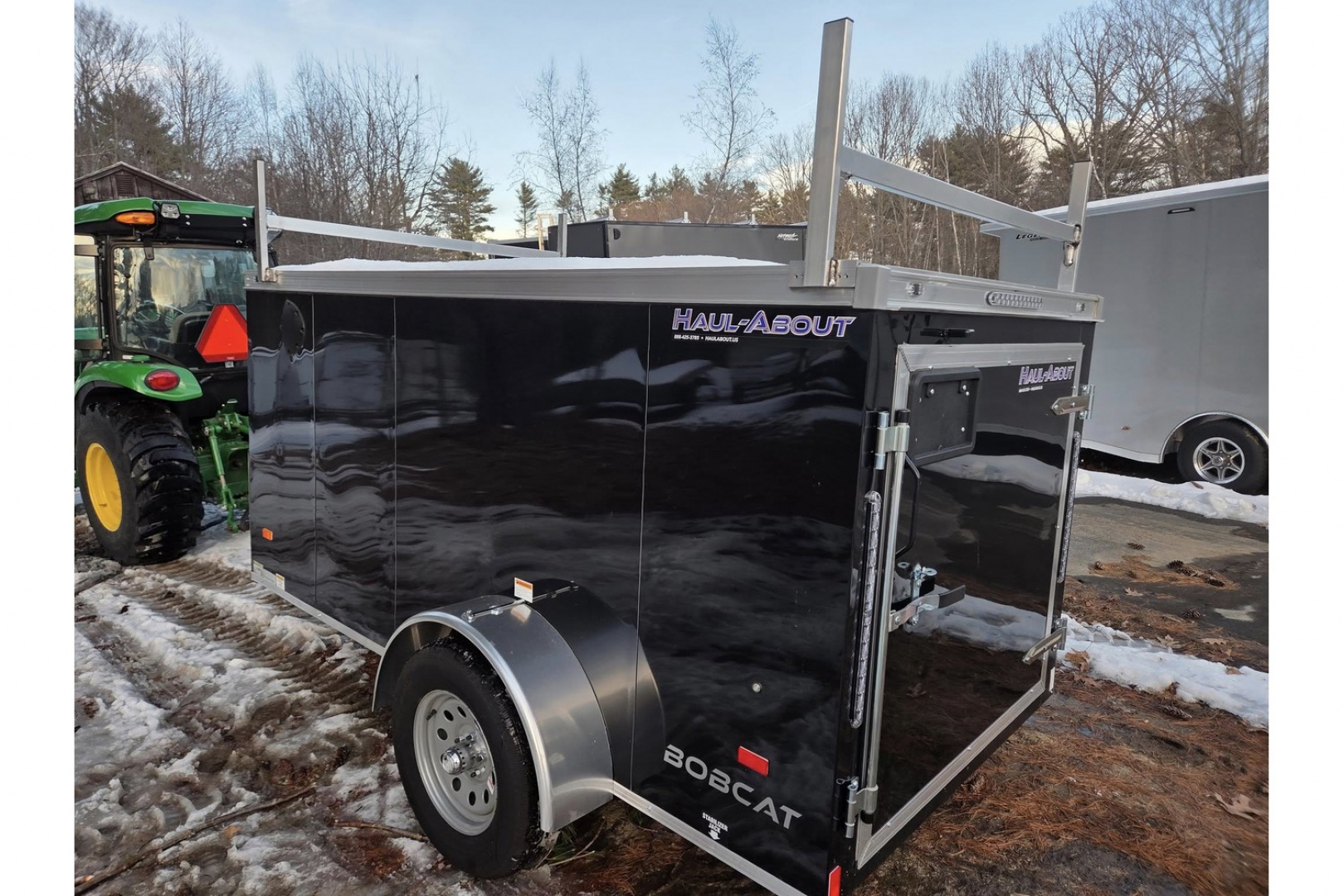 New 2026 5x10 enclosed cargo trailer with barn doors and ladder racks - Haul-About