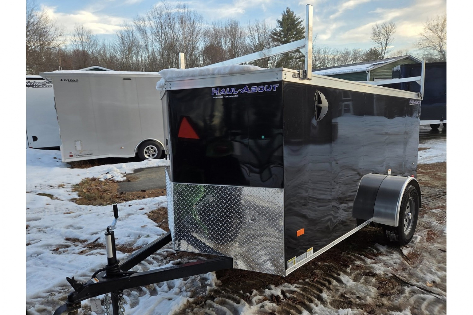 New 2026 5x10 enclosed cargo trailer with barn doors and ladder racks - Haul-About