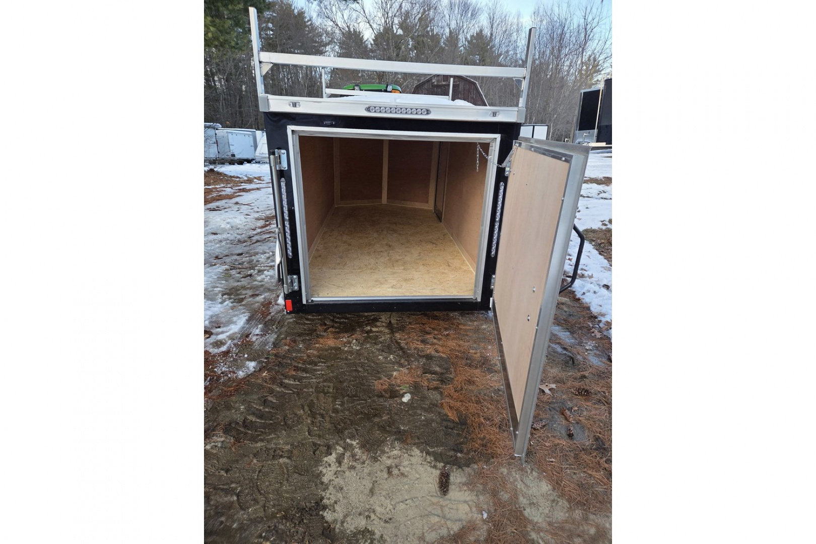 New 2026 5x10 enclosed cargo trailer with barn doors and ladder racks - Haul-About