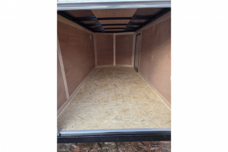 New 2026 5x10 enclosed cargo trailer with barn doors and ladder racks - Haul-About