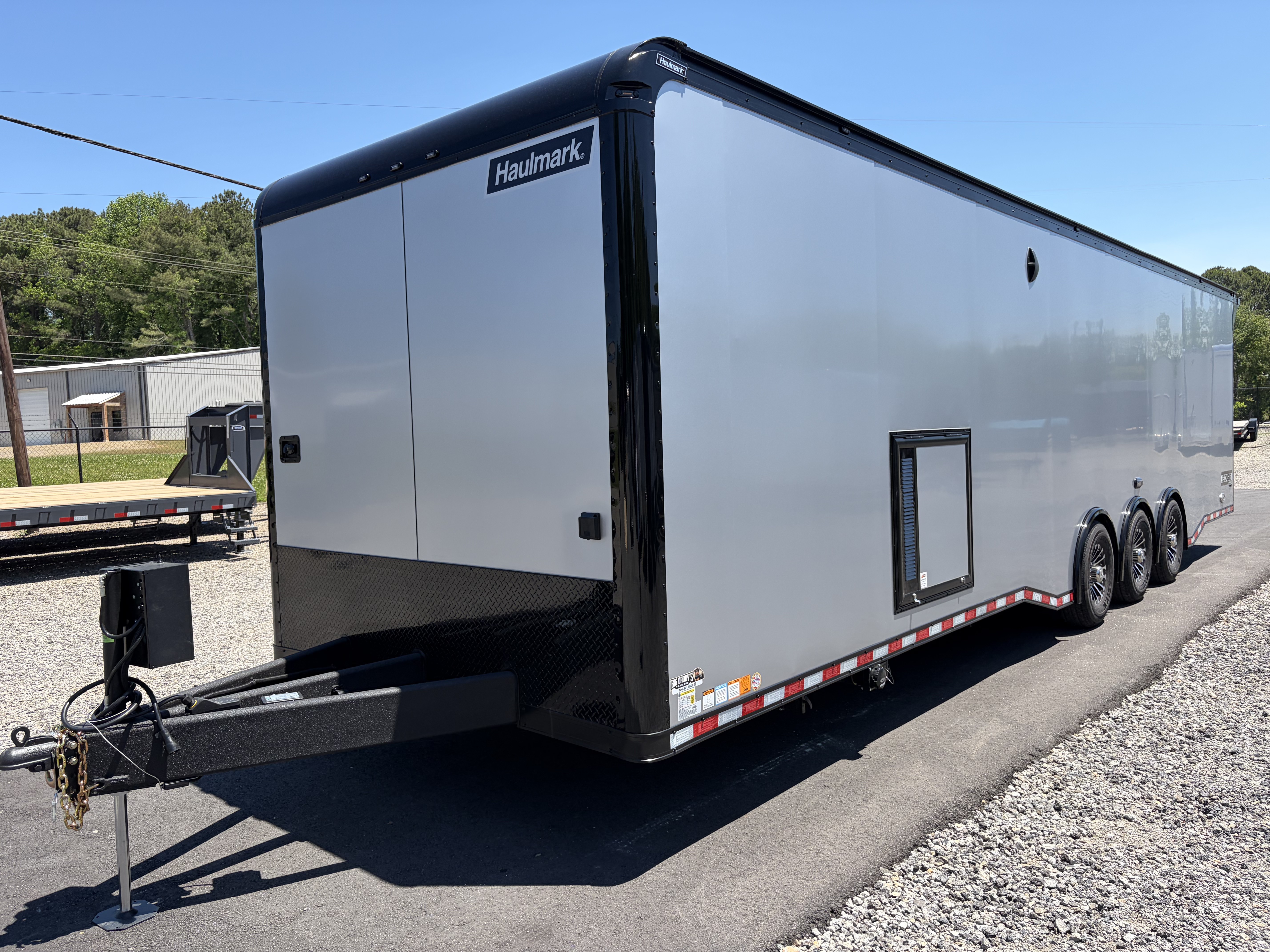 New 2026 Haulmark 34 Bathroom Race Trailer, Air Prep PKG, Awning, Polycor, Insulated, Window, 54" ALX Slide Out Step, A/C + Heat