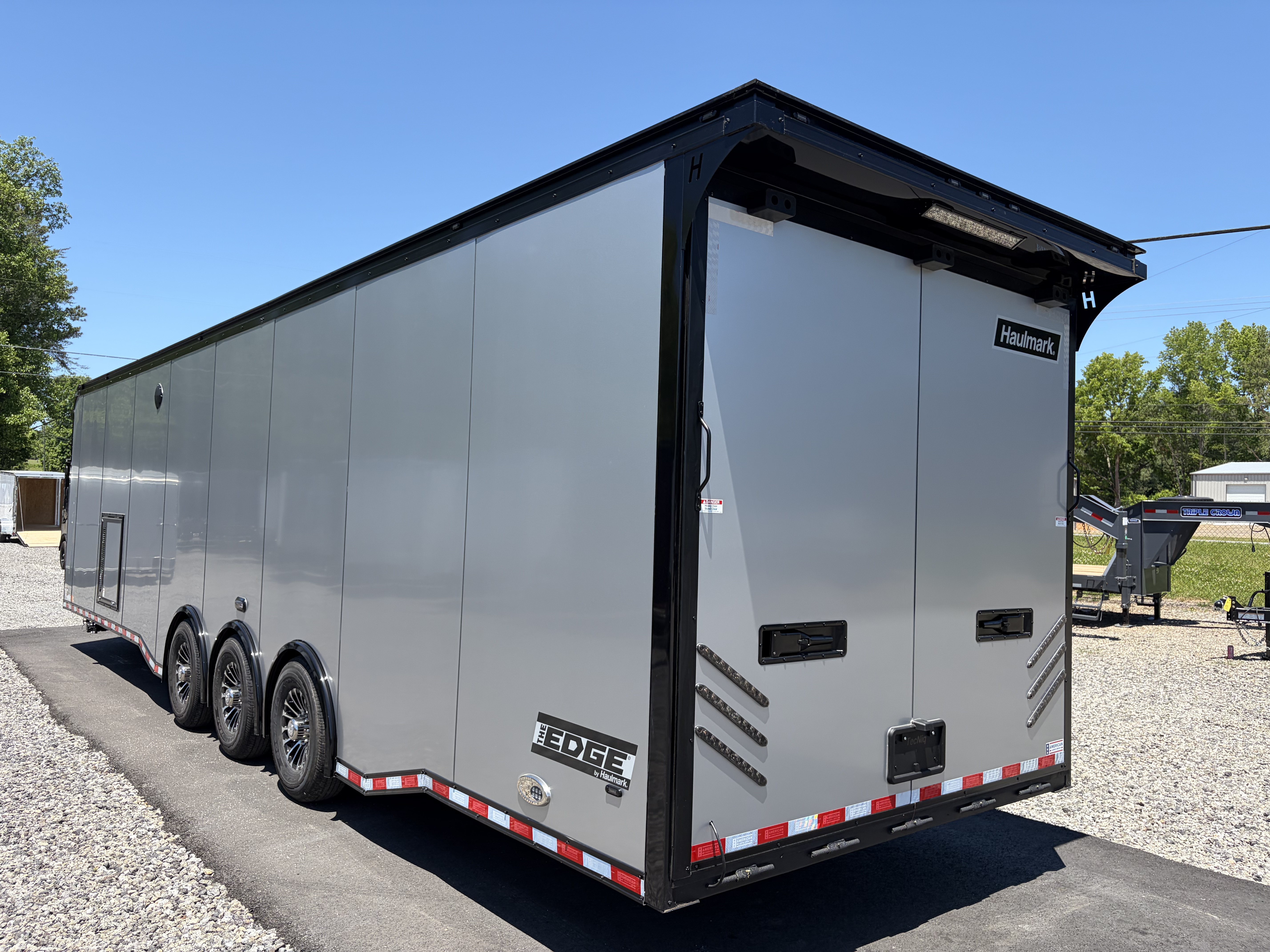 New 2026 Haulmark 34 Bathroom Race Trailer, Air Prep PKG, Awning, Polycor, Insulated, Window, 54" ALX Slide Out Step, A/C + Heat
