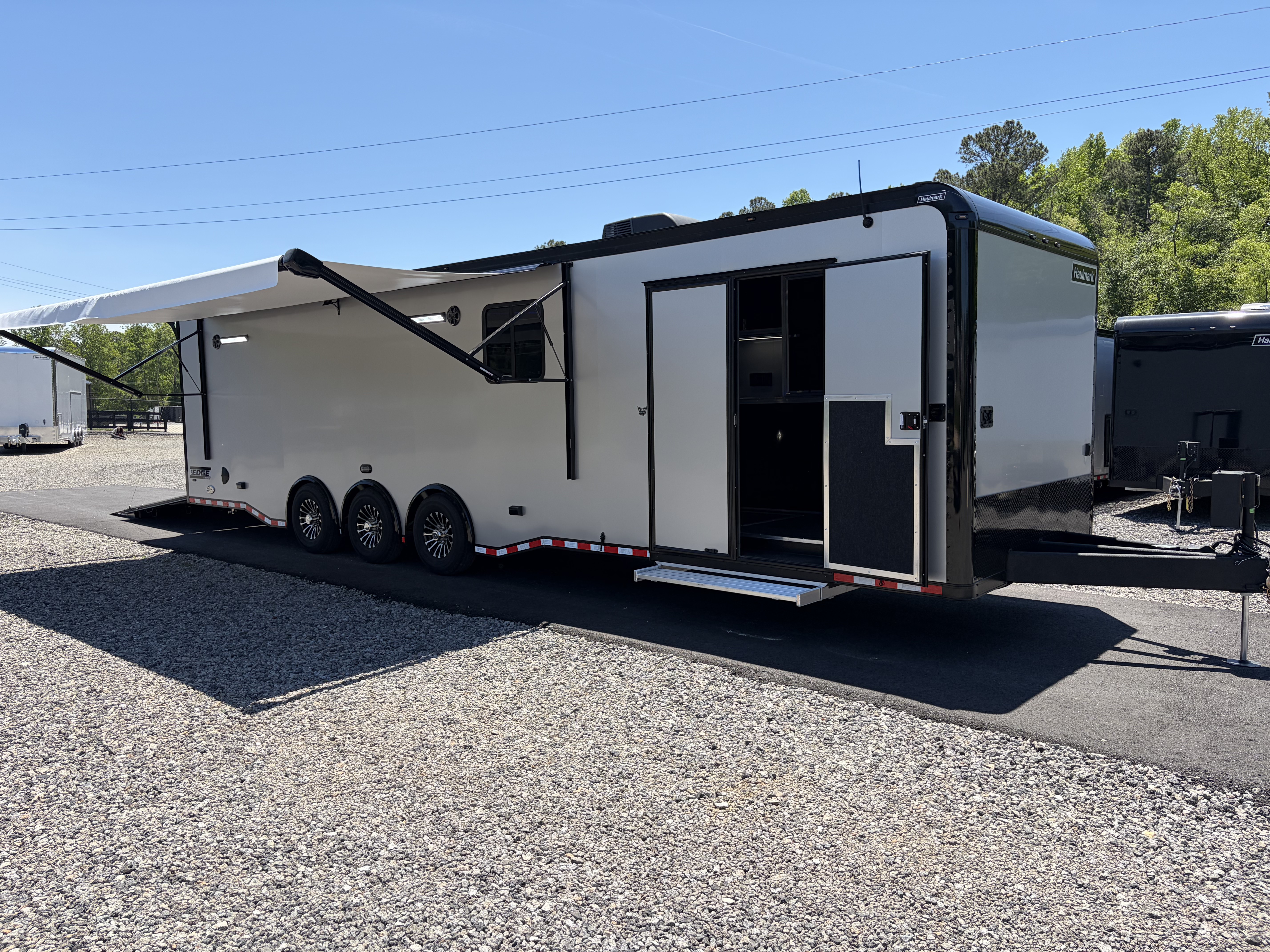 New 2026 Haulmark 34 Bathroom Race Trailer, Air Prep PKG, Awning, Polycor, Insulated, Window, 54  ALX Slide Out Step, A/C + Heat